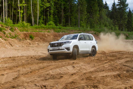 MOSCOW, RUSSIA - JUNE 02, 2021 Toyota Land Cruiser Prado model year 2021. SUV model year 2021 on nature background. Toyota Land Cruiser Prado in motion on the sand.のeditorial素材