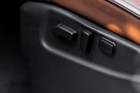Electric car seat adjustment control panel close up view. Adjustable car seat position. Car...
