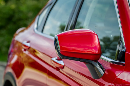 Close up front view of car side mirror. Front rear view mirror on the car window. Car exterior...