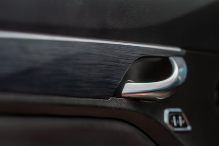Modern car interior door handle close up. Metallic Car door opener handle inside.の写真素材