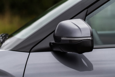Close up front view of car side mirror. Front rear view mirror on the car window. Car exterior...
