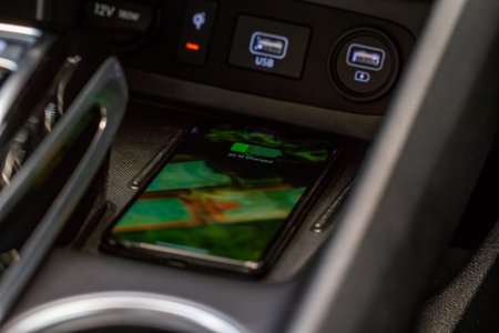 Wireless mobile charger in the modern car. Portable wireless car charger for smartphone.