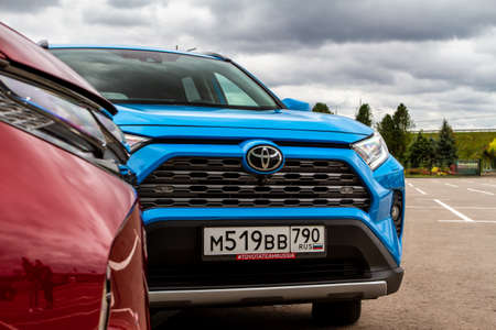 MOSCOW, RUSSIA - SEPTEMBER 9, 2021 Toyota RAV4 (XA50), a compact crossover SUV car model year 2021 on city background. Exterior front side close up view.のeditorial素材