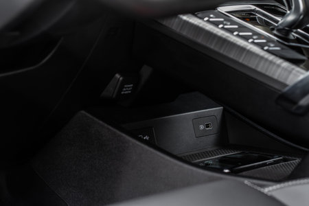 Opened car USB port in the car for connecting device. Power output of usb charger close up view. Car...