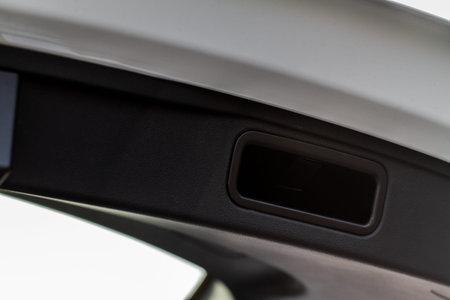 Trunk door handle. Modern car trunk door opened.