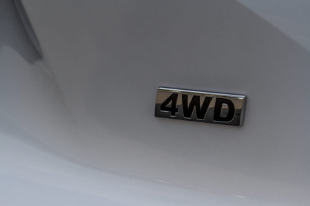 4WD emblem on modern SUV car detail close up view. Four Wheel Drive chrome badge.