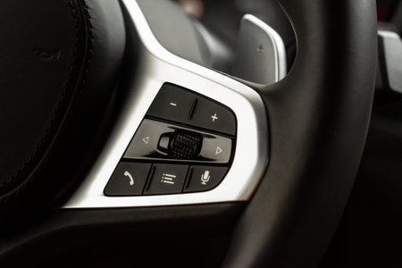 Call buttons on car steering wheel. Audio control buttons on the steering wheel of a modern car.