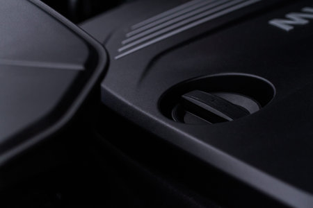 Closeup engine oil cap in engine room of a modern car. Oil cap on the car engine. engine oil...