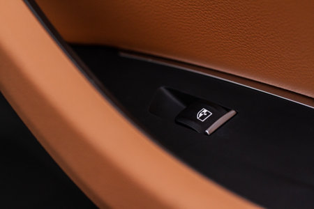 Close up view of button controlling window in modern car interior. Vehicle interior detail. Door handle with windows controlsの写真素材