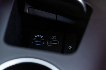 Opened car USB port in the car for connecting device. Power output of usb charger close up view. Car...