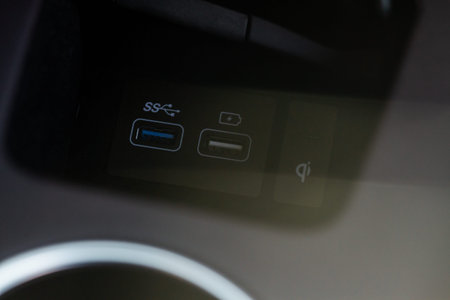 Opened car USB port in the car for connecting device. Power output of usb charger close up view. Car...
