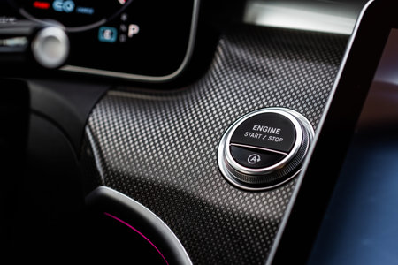 Close up engine car start stop button. Modern car black interior details.