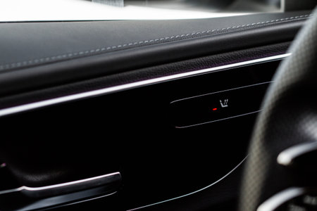 Seat heating controller buttons close up view. car interior. Seat heater button, car interior. The...