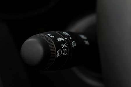 Modern car light switch. Turning on headlight in the car. Close up of car light control.の写真素材