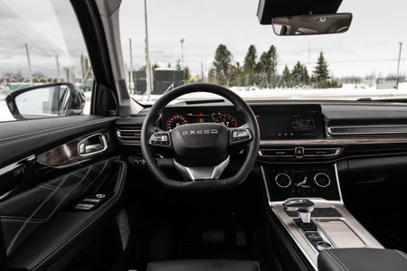 Moscow, Russia - December 18, 2021 Exeed VX also called Lanyue, interior view. Midsize modern crossover SUV. Exeed logo on the car steering wheel.のeditorial素材