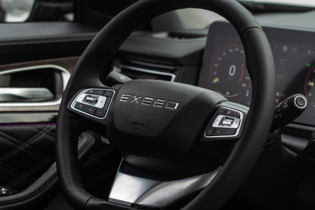 Moscow, Russia - December 18, 2021 Exeed VX also called Lanyue, interior view. Compact luxury SUV. Exeed logo on the car steering wheel.のeditorial素材