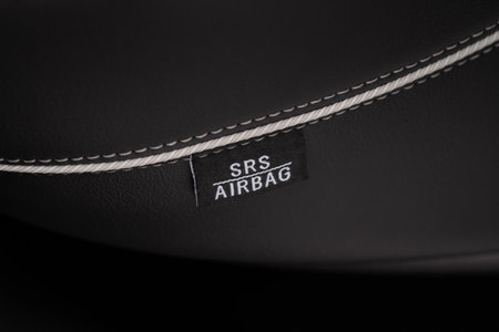 Close up view of airbag label on the side of a car seat. Airbag safety system symbol on the car seat. Modern car interior details.の写真素材
