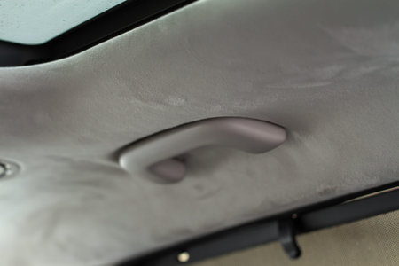 Modern car grab handle, car interior details. Car grab handler for the passenger. Car ceiling...