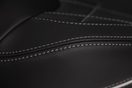 High angle view of modern car fabric seats. Close-up car seat texture and interior details. Detailed image of a car pleats stitch work. Leather seats.の写真素材