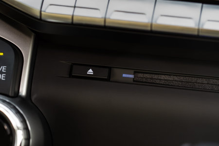 Car CD slot bay and radio control panel close up view