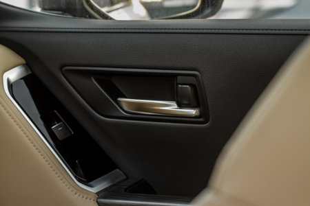 Car door handle closeup view. car interior door panel. Modern car door panel close-up view.の写真素材