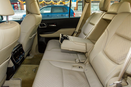 modern car inside. Leather passenger seats with opened armrest. Comfortable leather seats. Central armrest for rear seatの写真素材