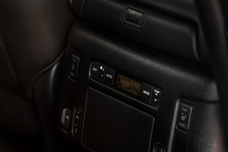 modern car. Digital second row seat temperature control. Car air conditioning system button. automatic climate control system. Fan speed and temperature control.の写真素材