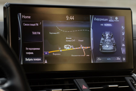 Modern car media display in the interior of the car. Translation "Stations list. No connected phone. Chose phone. Information. Different names of villages"の写真素材