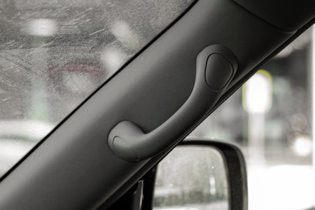 Modern car grab handle, car interior details. Car grab handler for the passenger. Car ceiling handle.の写真素材