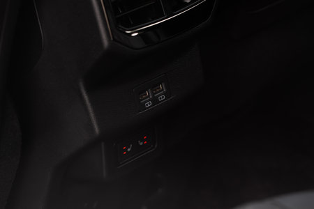Opened car USB port in the car for connecting device. Power output of usb charger close up view. Car interior.の写真素材