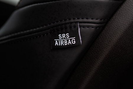 Close up view of airbag label on the side of a car seat. Airbag safety system symbol on the car seat. Modern car interior details.の写真素材