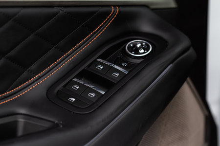 Window control buttons in modern car. car window control panel. Modern car window switch. Door handle with power window control.の写真素材