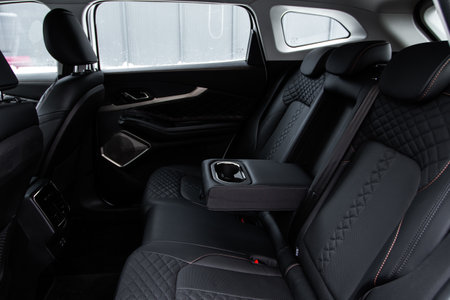 modern car inside. Leather passenger seats with opened armrest. Comfortable leather seats. Central armrest for rear seatの写真素材