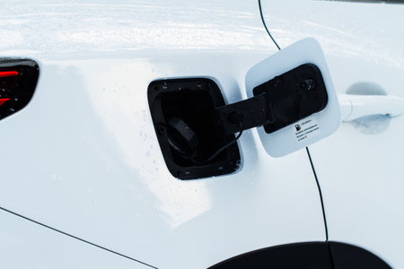 Exterior of car with fuel filler door open. Opened fuel tank cap of a car for filling gasoline or diesel fuel into the tank. Translation "Use 92 Octane rating fuel minimal"の写真素材