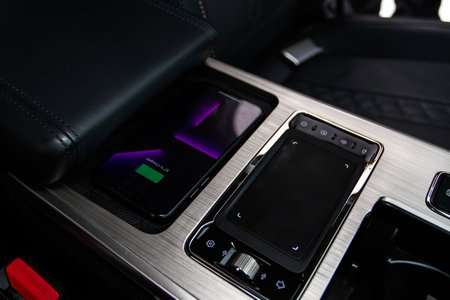 Wireless mobile charger in the modern car. Portable wireless car charger for smartphone.の写真素材