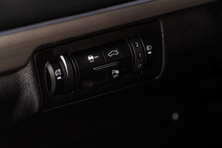 Hand operating ESP (electronic stability program) control close up view. Interior detail of a modern car. ESP button.の写真素材
