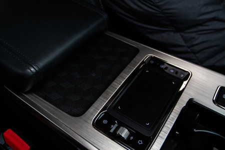 Wireless mobile charger in the modern car. Portable wireless car charger for smartphone.の写真素材
