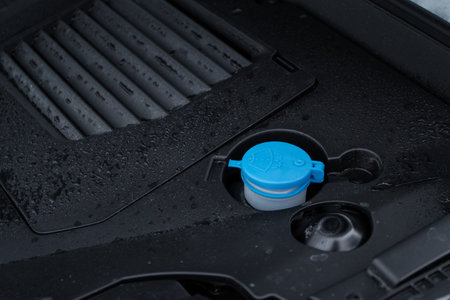 Closeup blue windshield washer fluid reservoir cap. Car engine windshield washer fluid reservoir cap close-upの写真素材