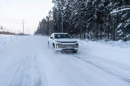 Moscow, Russia - December 25, 2021 Chery Exeed TXL car also called Vantas TX, midsize crossover car. Exterior front-side view on blurred winter background. Exeed car in motion.のeditorial素材