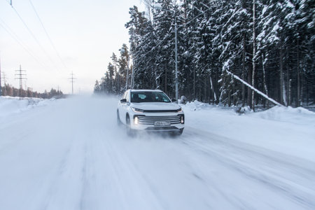 Moscow, Russia - December 25, 2021 Chery Exeed TXL car also called Vantas TX, midsize crossover car. Exterior front-side view on blurred winter background. Exeed car in motion.のeditorial素材