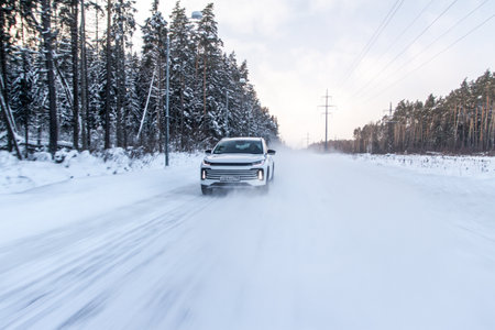 Moscow, Russia - December 25, 2021 Chery Exeed TXL car also called Vantas TX, midsize crossover car. Exterior front-side view on blurred winter background. Exeed car in motion.のeditorial素材