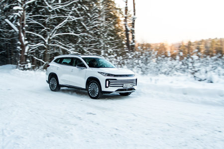 Moscow, Russia - December 25, 2021 Chery Exeed TXL car also called Vantas TX, midsize crossover car. Exterior front-side view on blurred winter background. Exeed car in motion.のeditorial素材