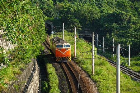 Train approaching the Chongde Tunnel, where is near by Chingshui Cliff on the Su-Hua Highway, Xiulin township, Hualien County, Taiwanのeditorial素材