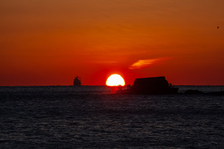 Fishermen on a small island, the burning sun and beautiful scenery made by shipsの写真素材