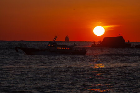 Fishermen on a small island, the burning sun and beautiful scenery made by shipsの写真素材