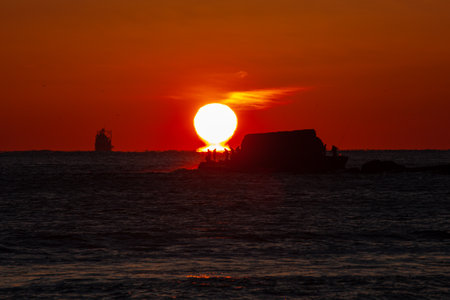 Fishermen on a small island, the burning sun and beautiful scenery made by shipsの写真素材