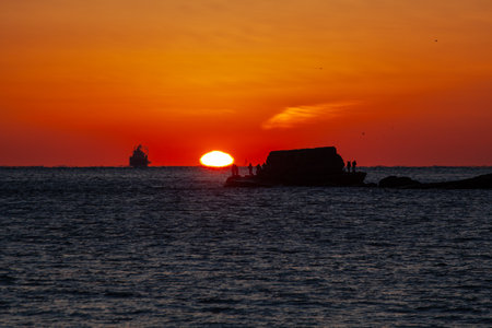 Fishermen on a small island, the sun and beautiful scenery made by shipsの写真素材