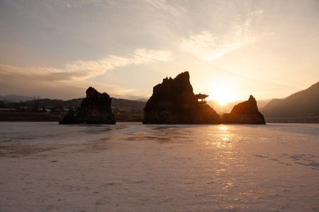 A small island with a pavilion, a frozen river, a morning sunrise sceneの写真素材