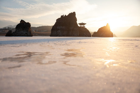 A small island with a pavilion, a frozen river, a morning sunrise scene. bokeh.の写真素材