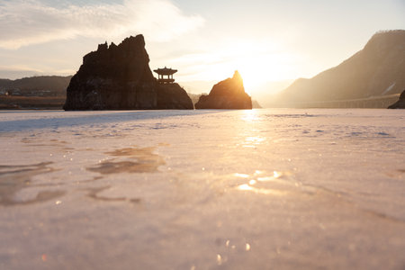 A small island with a pavilion, a frozen river, a morning sunrise sceneの写真素材